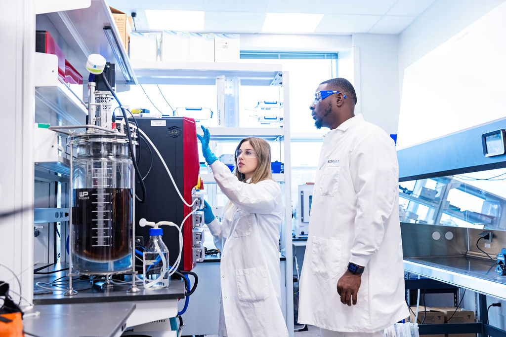 BiomEdit scientists examining lab equipment